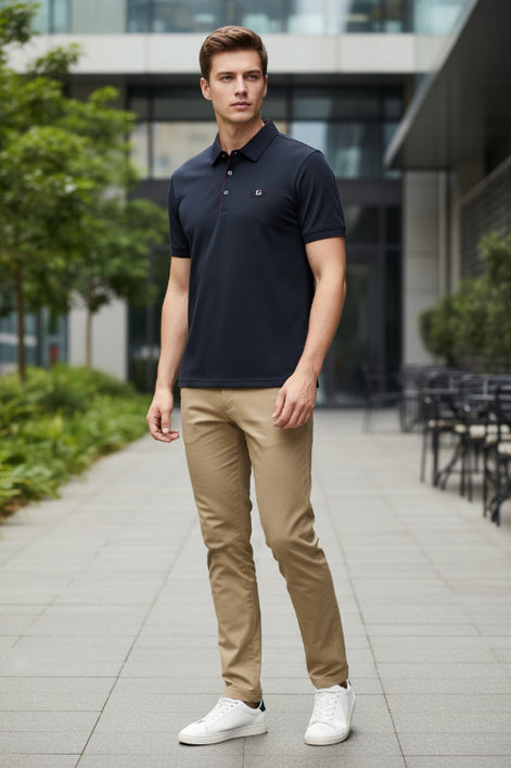 Dark blue shirt with red stitching on a hanger, held by a hand.