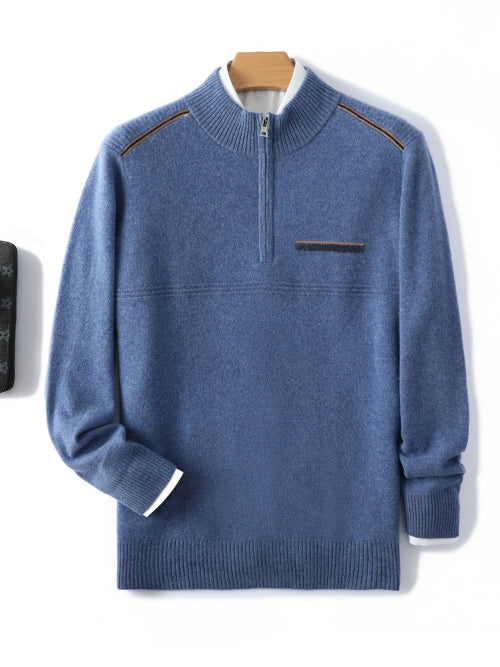 Blue quarter-zip mock-neck sweater with contrast stitching on the shoulders, displayed against a white background with a wooden hanger visible behind the collar.