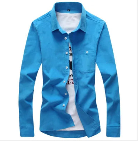A men's long-sleeve button-up shirt in bright blue, styled open over a white graphic t-shirt. The shirt features a classic collar, 