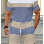 A man wearing a matching two-piece colorblock athletic set with a short-sleeve t-shirt and shorts. 