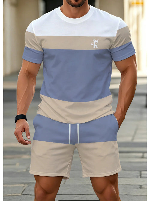 A man wearing a matching two-piece colorblock athletic set with a short-sleeve t-shirt and shorts. 
