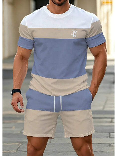 A man wearing a matching two-piece colorblock athletic set with a short-sleeve t-shirt and shorts. 