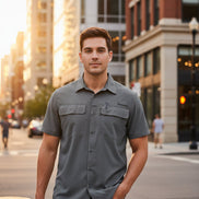 Man wearing a gray short-sleeve shirt with pockets on a white background