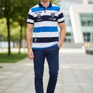 A short-sleeve polo shirt with horizontal stripes in white, blue, and navy, featuring various printed patches and logos on the chest and sleeves. The brand 'TACE&SHARK' 