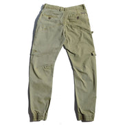 Back view of light khaki cargo pants laid flat against a white background, showing buttoned back pockets, angled seams, and gathered ankle cuffs.