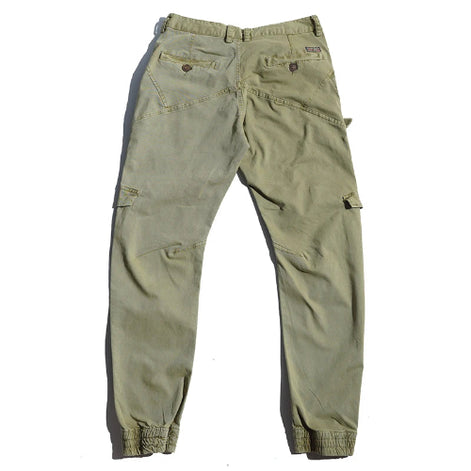 Back view of light khaki cargo pants laid flat against a white background, showing buttoned back pockets, angled seams, and gathered ankle cuffs.