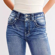 Close-up of blue jeans with a plain background