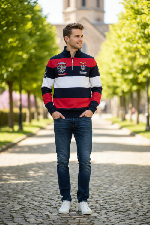 A men's long-sleeve rugby-style quarter-zip pullover with bold horizontal stripes in navy blue, red, and white. The shirt features a mock neck, a silver zipper, a 'Kingfish' 