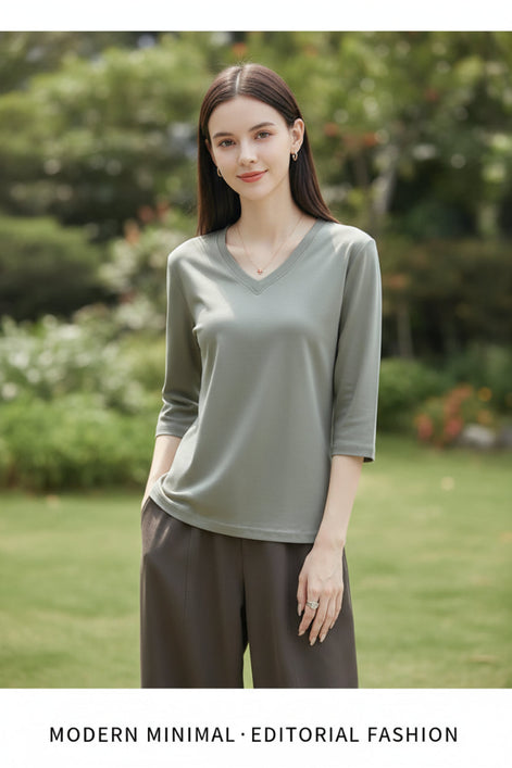 Woman wearing a gray t-shirt with a neutral background