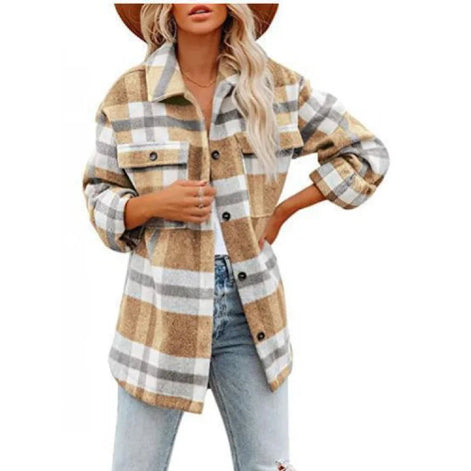 Woman wearing a tan and gray plaid shirt with jeans, against a white background.