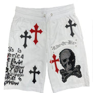 White shorts with black and red crosses and a skull design on a white background