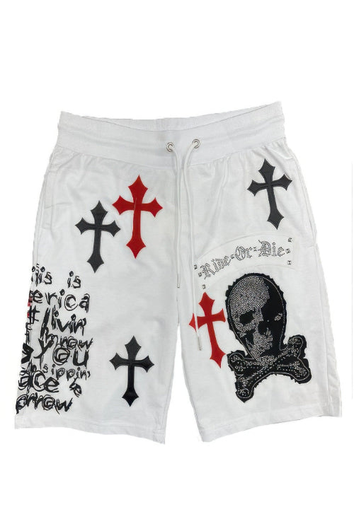 White shorts with black and red crosses and a skull design on a white background
