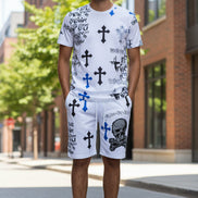 Person wearing white shorts with black and blue designs on a white background