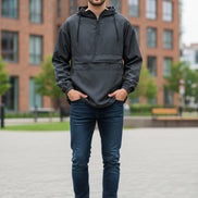 Man wearing a dark gray hooded jacket on a white background