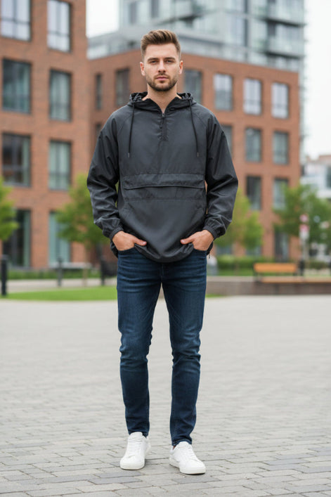 Man wearing a dark gray hooded jacket on a white background