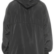 Person wearing a black hooded jacket on a white background