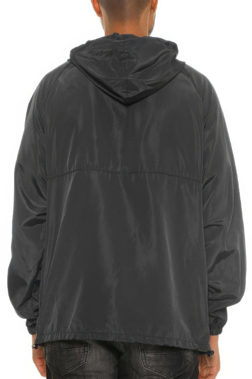 Person wearing a black hooded jacket on a white background