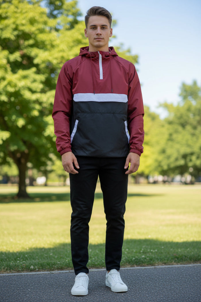 Person wearing a red and black jacket with a white zipper on a white background