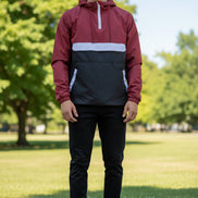 Person wearing a red and black jacket with a white zipper on a white background