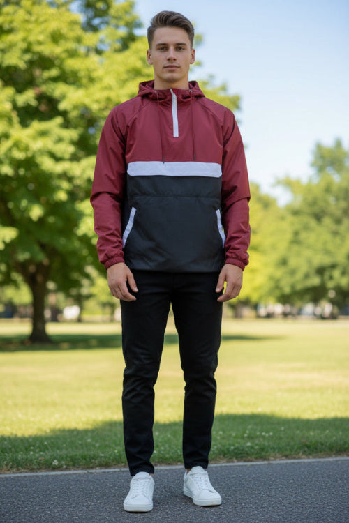 Person wearing a red and black jacket with a white zipper on a white background