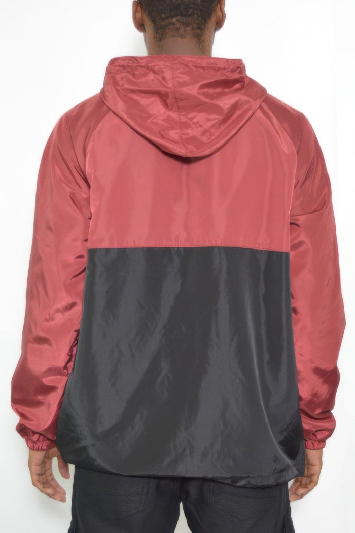 Person wearing a two-tone red and black jacket on a white background