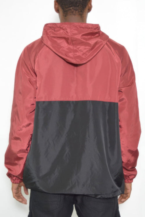 Person wearing a two-tone red and black jacket on a white background