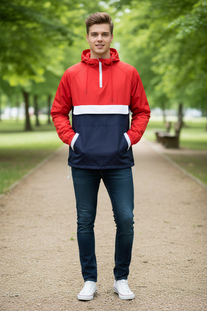 Person wearing a red and navy anorak jacket on a white background