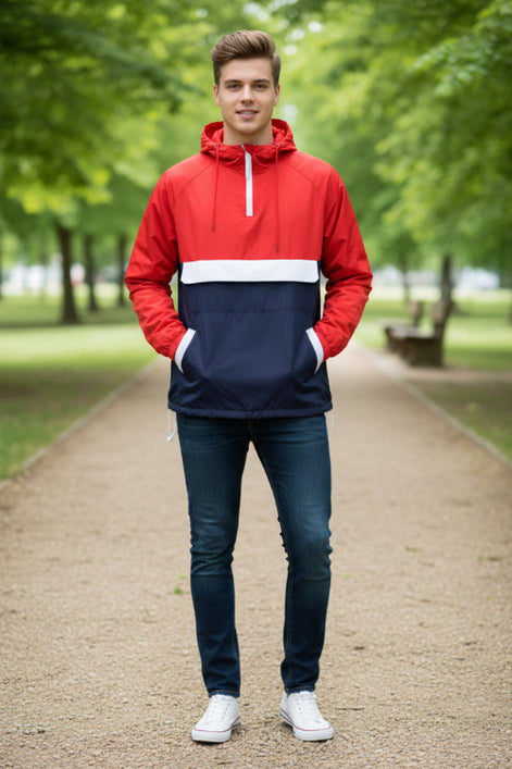 Person wearing a red and navy anorak jacket on a white background