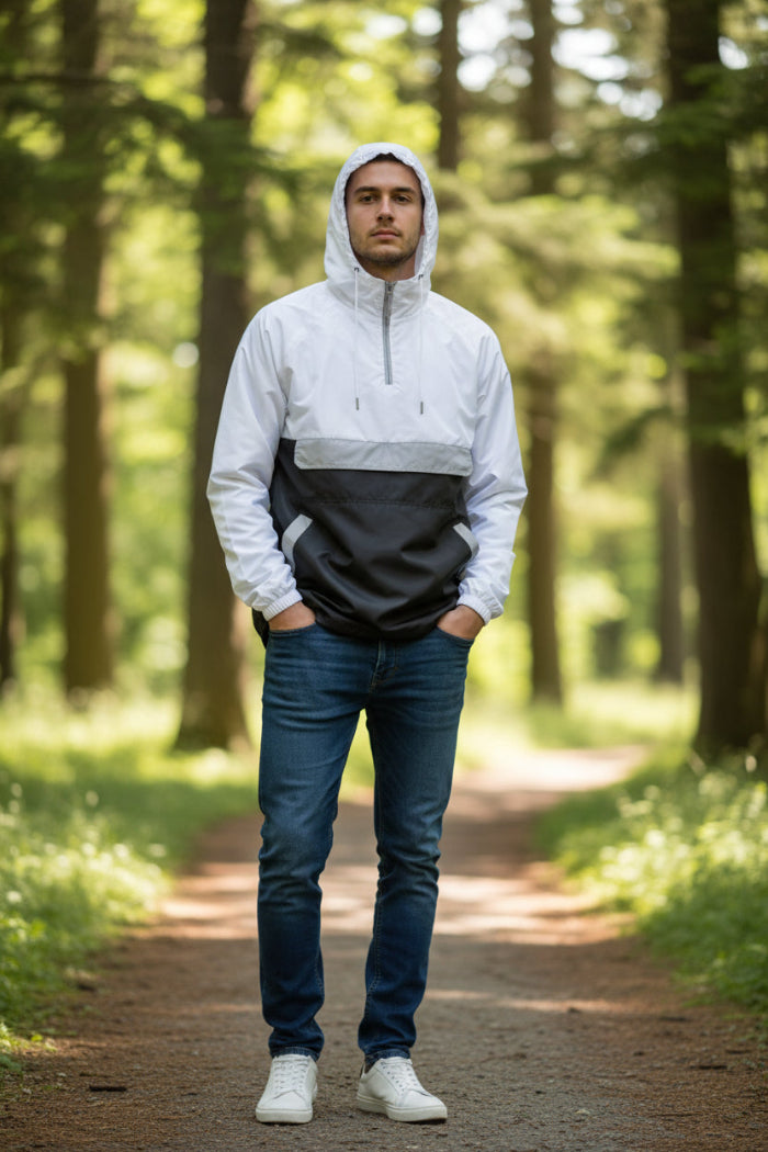 Person wearing a white and black jacket with a transparent panel over the chest on a white background
