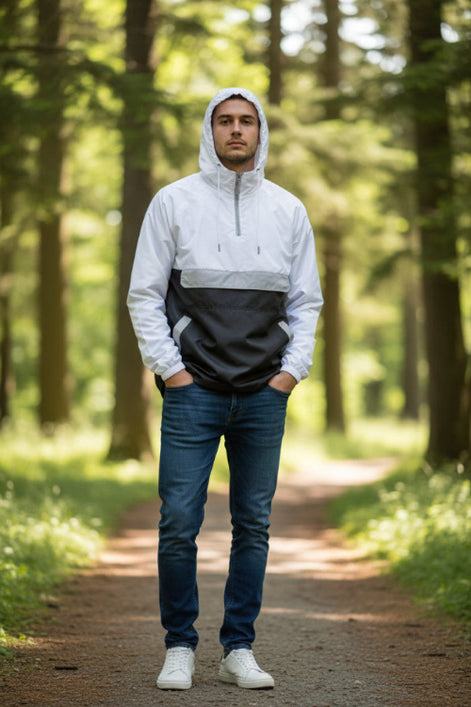 Person wearing a white and black jacket with a transparent panel over the chest on a white background