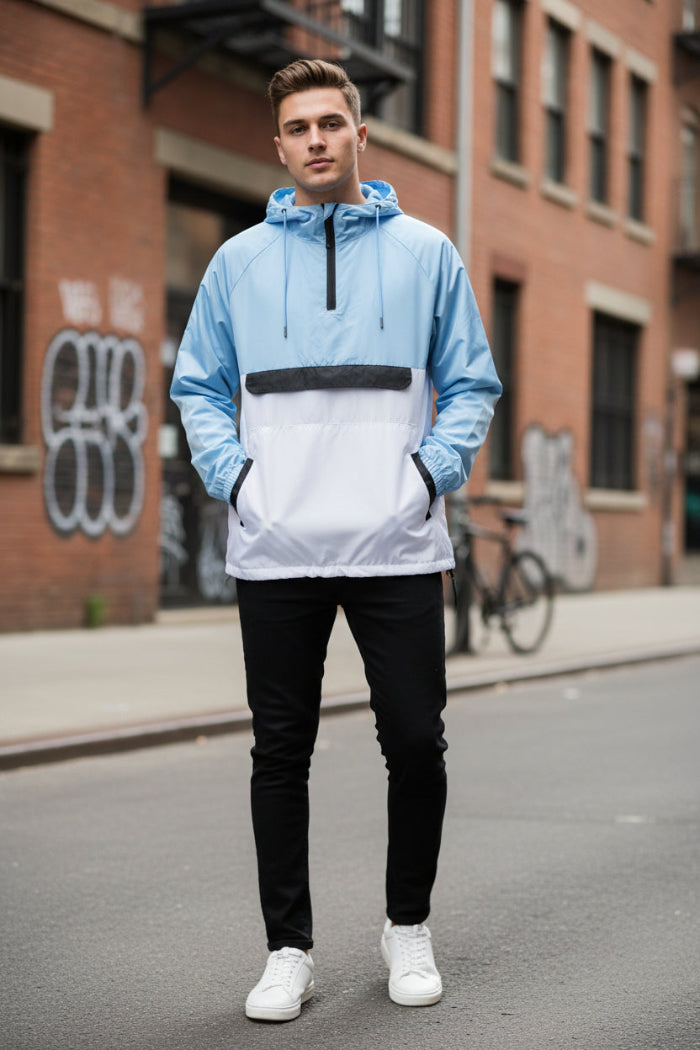 Person wearing a light blue and white jacket with black accents on a white background