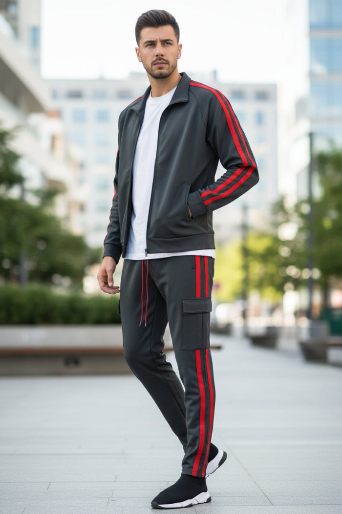 Man wearing a gray tracksuit with red stripes taken ouside