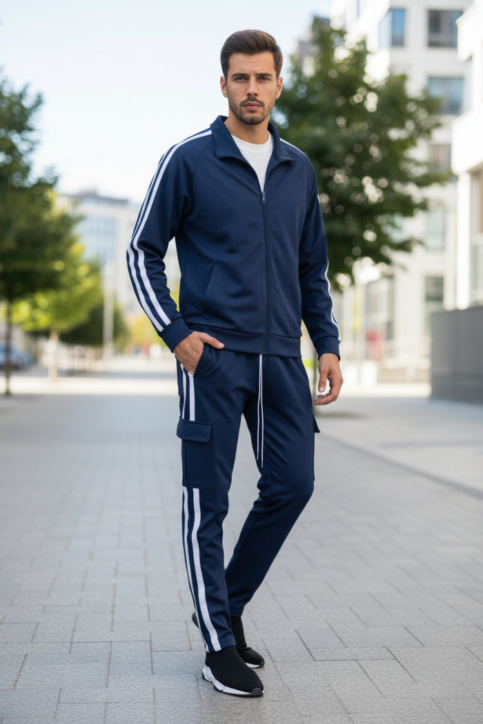 Person wearing a navy tracksuit with white stripes taken outside