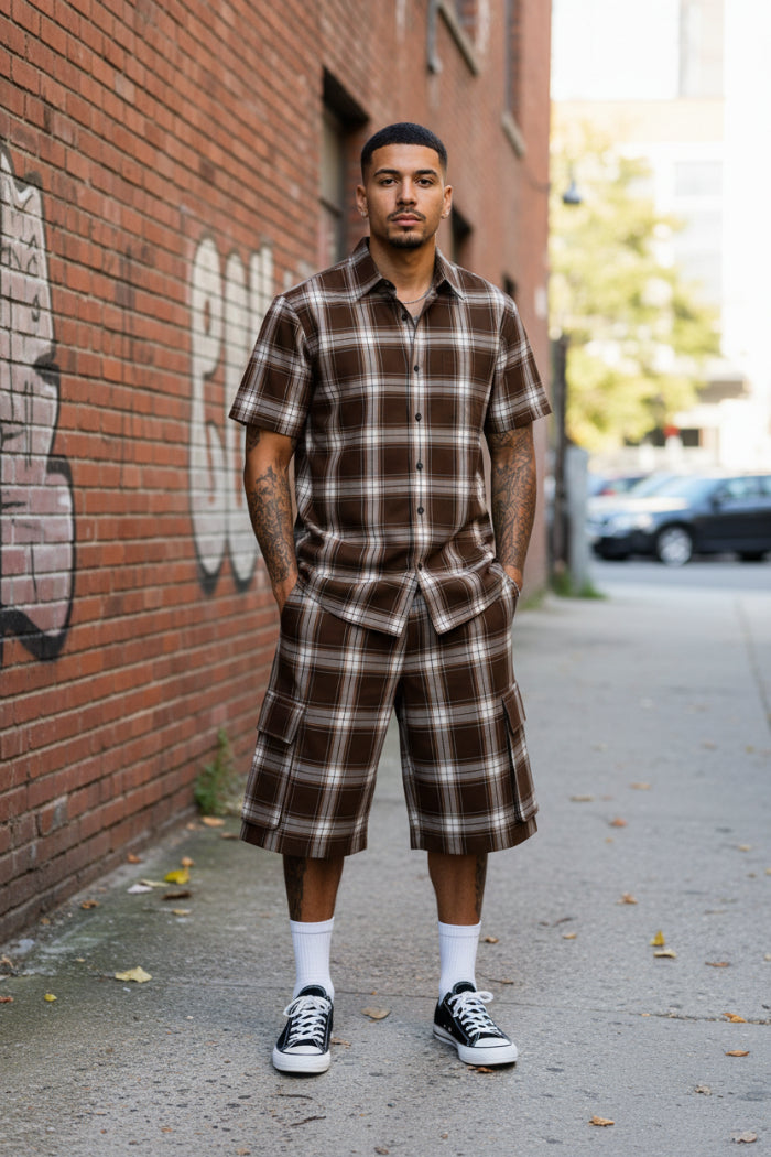 Person wearing a brown plaid shirt and shorts set taken outside