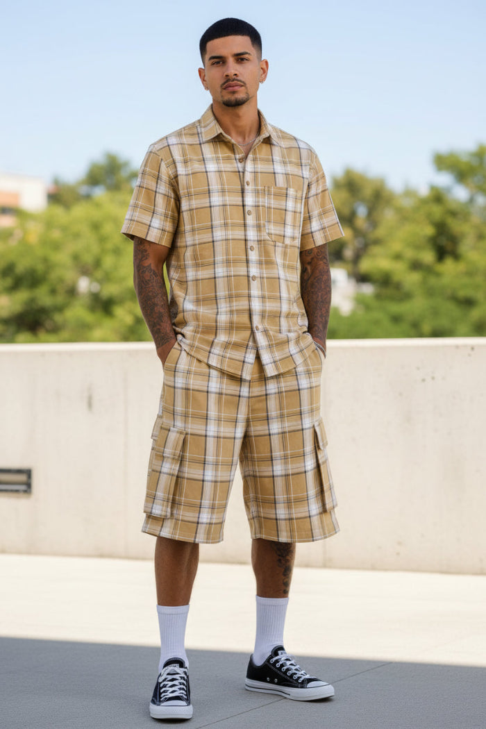 Person wearing a matching plaid shirt and shorts taken outide