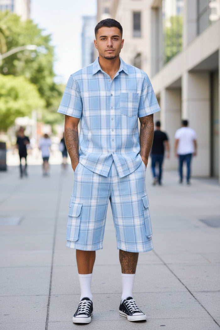 Person wearing a blue plaid outfit with a shirt and shorts  taken outside