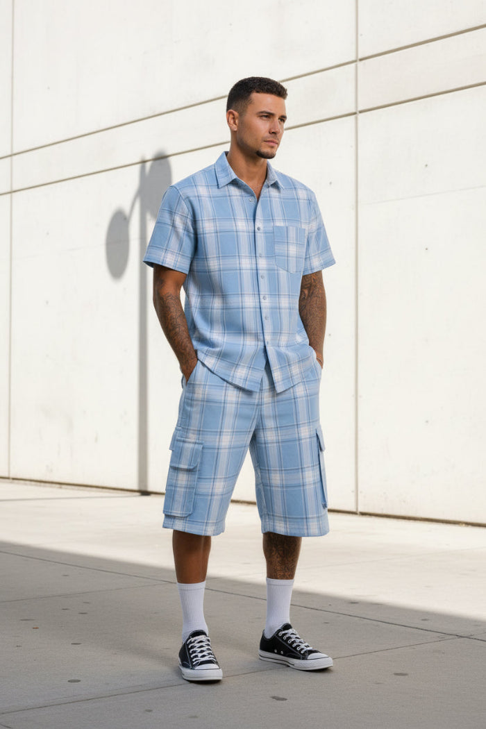 Person wearing a blue plaid outfit with a shirt and shorts taken outside