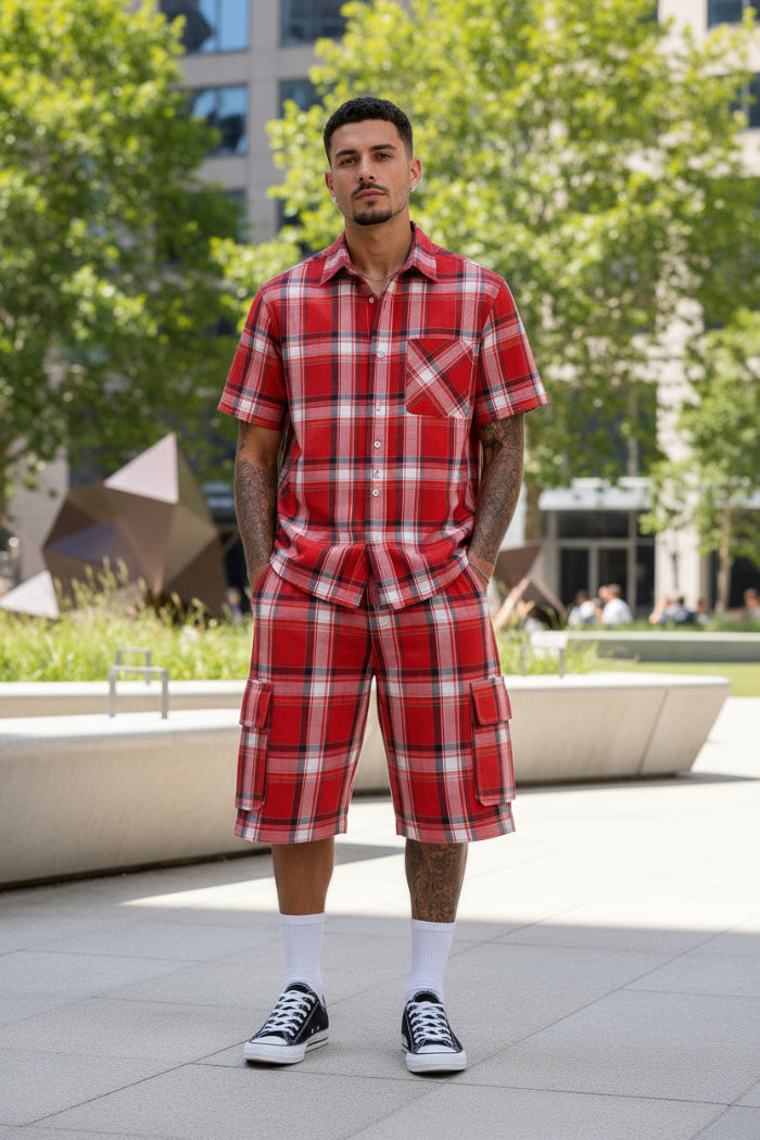 Person wearing a red plaid outfit with black Converse shoes taken outside