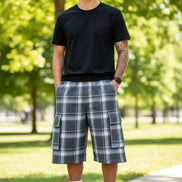 Person wearing plaid shorts with pockets on a white background