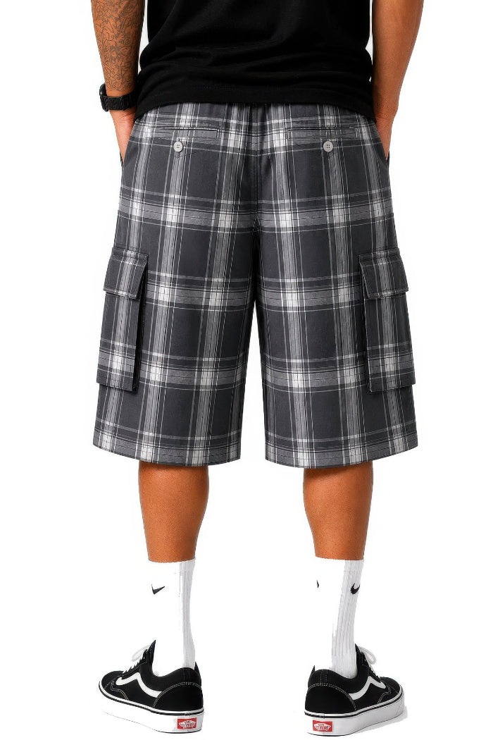 Person wearing plaid cargo shorts on a white background