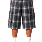 Person wearing plaid cargo shorts on a white background