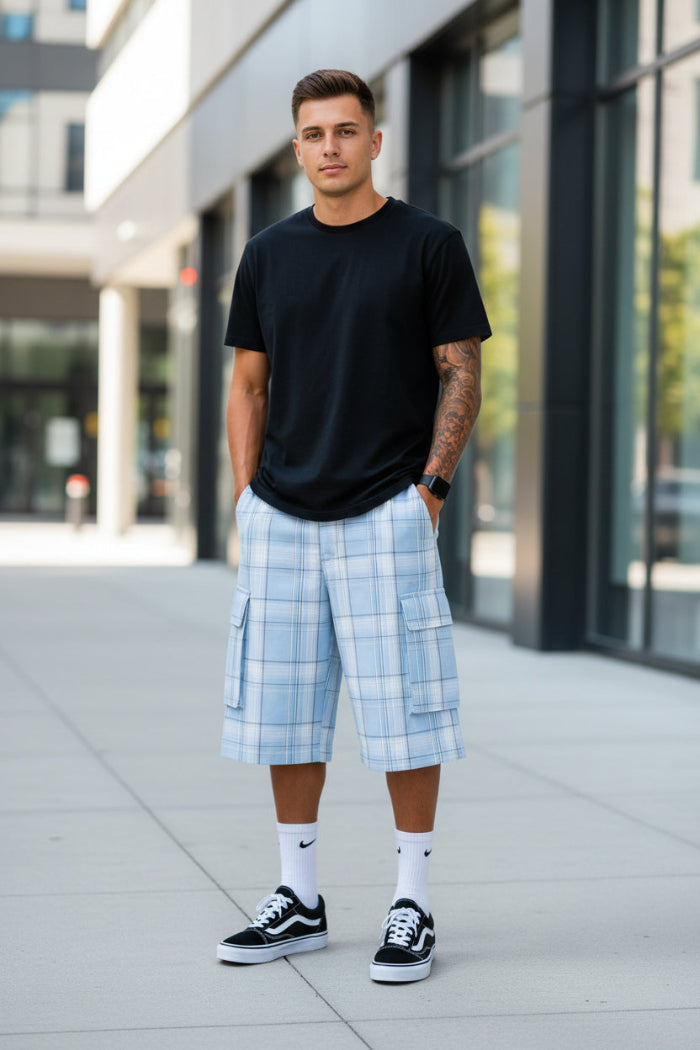 Person wearing light blue plaid shorts with pockets on a white background