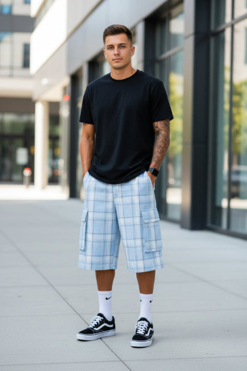 Person wearing light blue plaid shorts with pockets on a white background