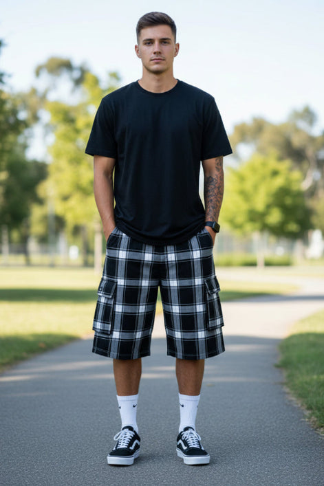 Person wearing black and white plaid cargo shorts on a white background