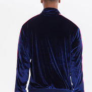 Person wearing a blue velvet tracksuit taken outside