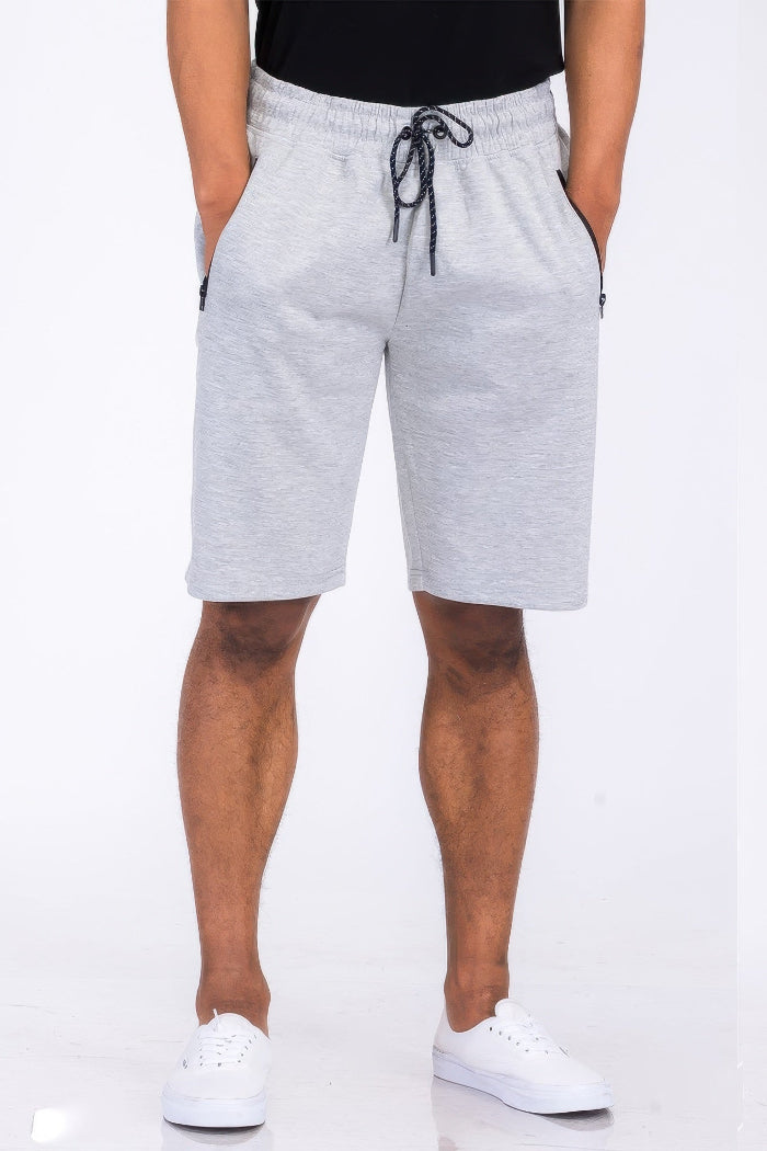Person wearing gray shorts on a white background