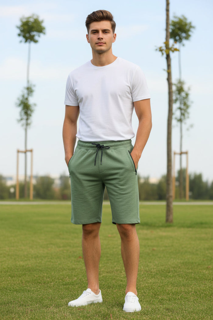 Person wearing green shorts on a white background