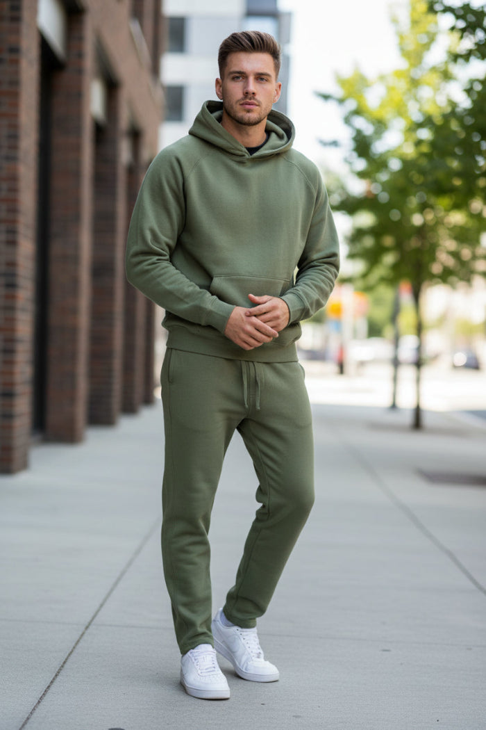 Person wearing a green tracksuit on a white background