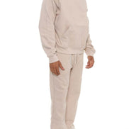 Man wearing a beige tracksuit on a white background
