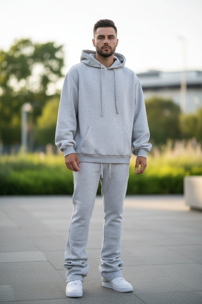 Person wearing a gray hoodie and pants set on outside